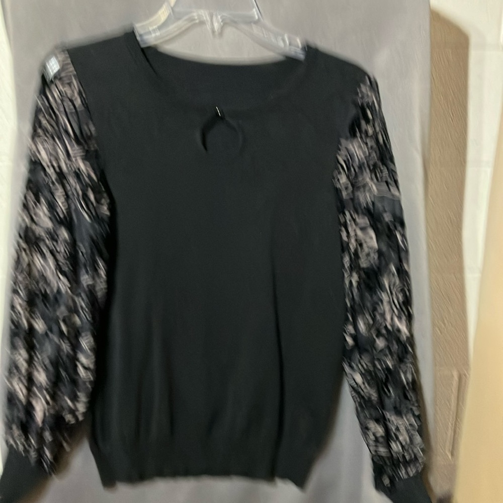 Dressy black sweater. Sheer sleeves with a floral pattern and burnout texture.